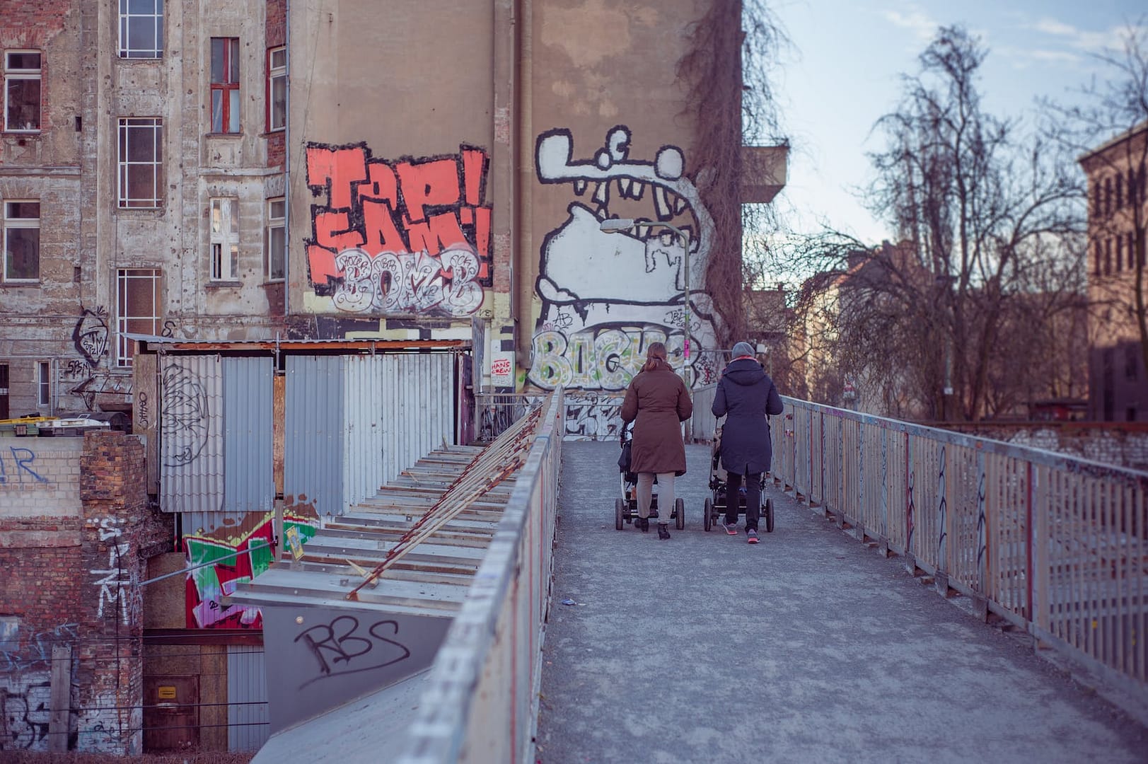 two people walking on bridge