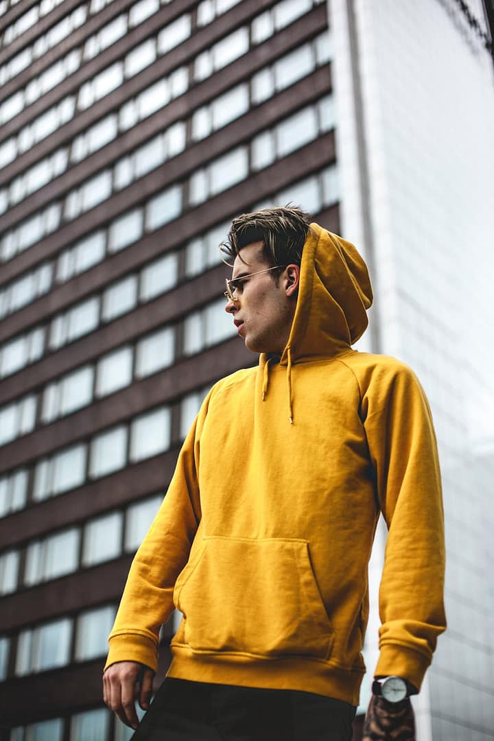 photography of guy wearing yellow hoodie